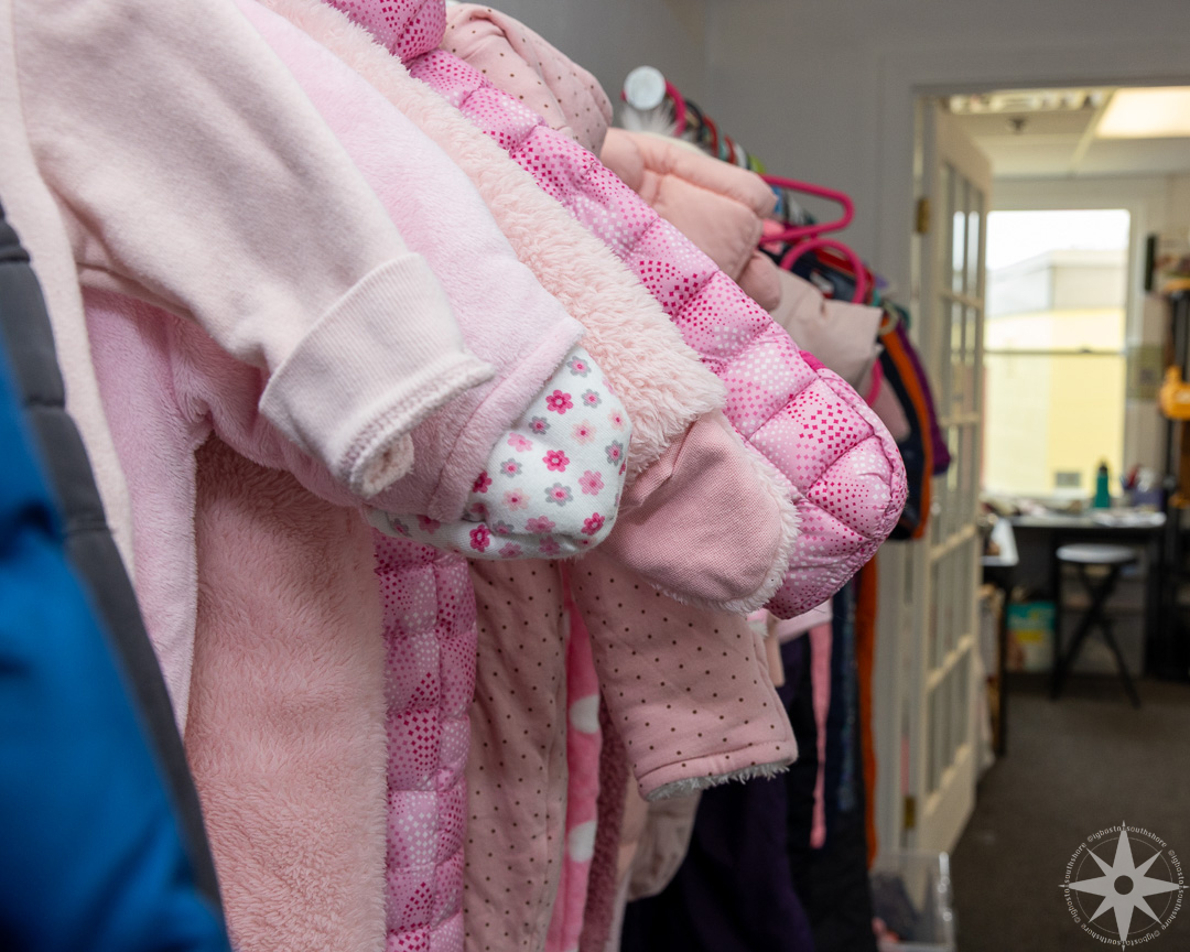 Families browsing and selecting clothing at the 143 Exchange
