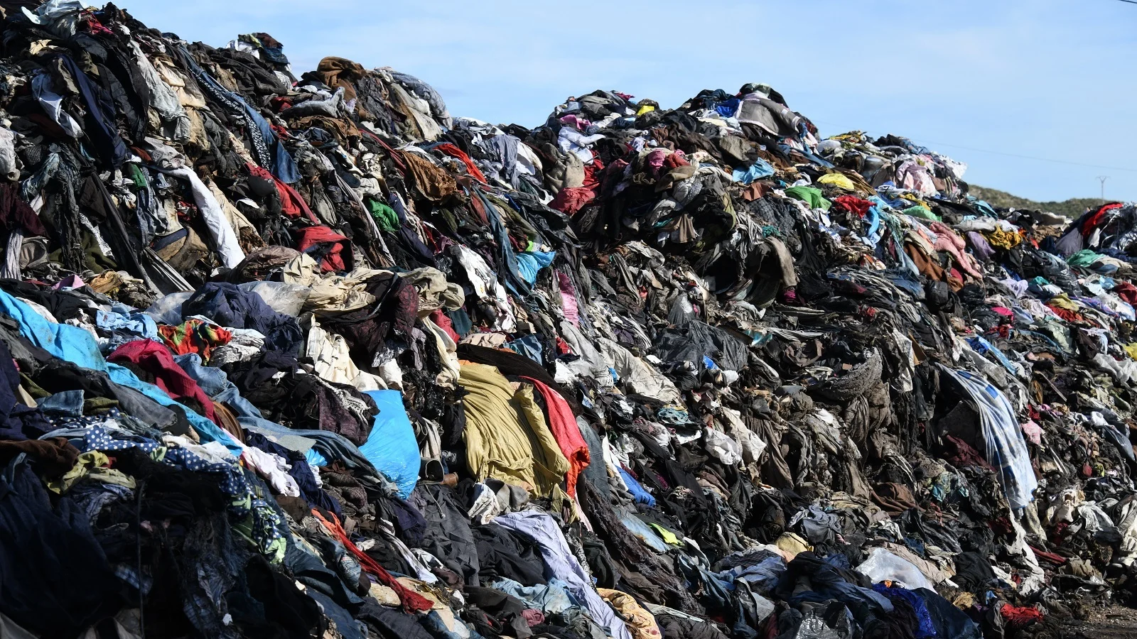 Pile of discarded clothing representing textile waste headed to landfills