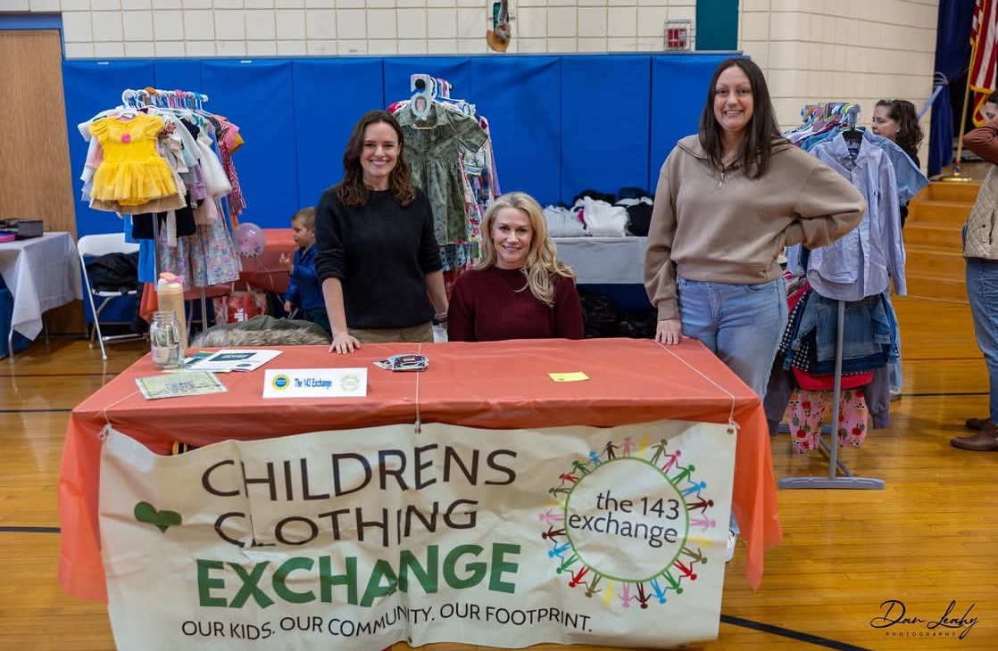 Volunteers sorting and organizing donated clothing at 143 Exchange